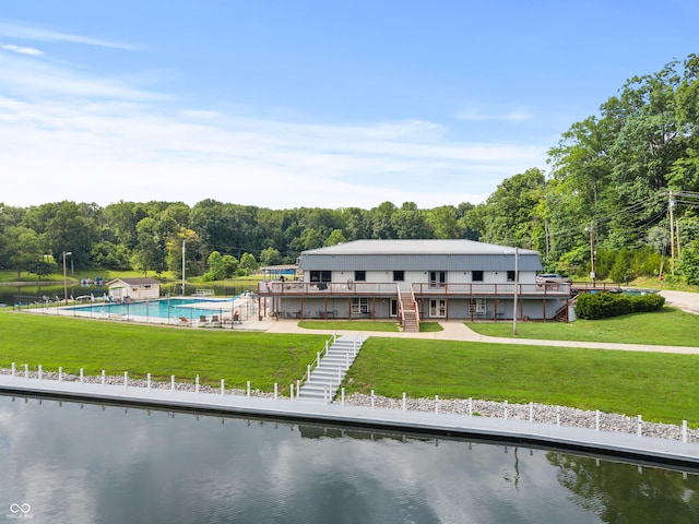 2591 S Glen Cv, Martinsville, IN 46151 - rear view of house with stairs, a lawn, a community pool, a deck with water view, and a view of trees