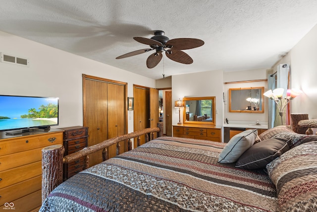 2591 S Glen Cv, Martinsville, IN 46151 - bedroom with multiple closets, a textured ceiling, and a ceiling fan