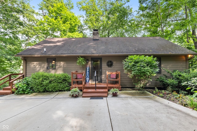 2591 S Glen Cv, Martinsville, IN 46151 - single story home featuring a patio area, a deck, a chimney, and roof with shingles