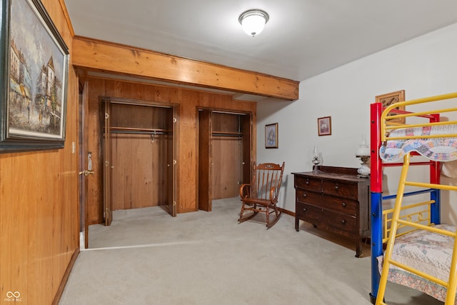 2591 S Glen Cv, Martinsville, IN 46151 - bedroom with carpet floors, two closets, wood walls, and beam ceiling