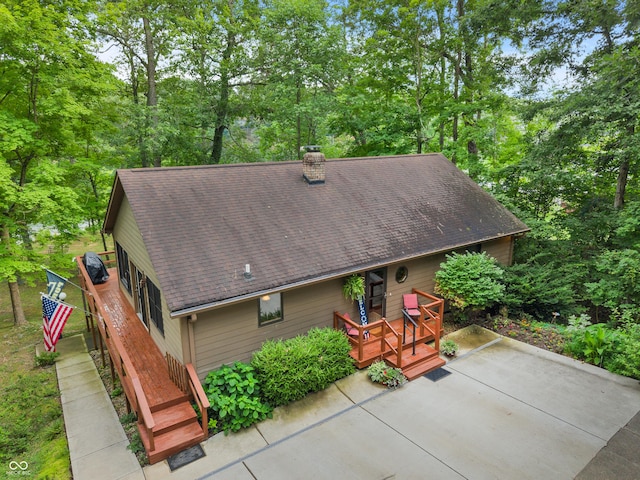 2591 S Glen Cv, Martinsville, IN 46151 - back of house featuring a shingled roof, a patio area, a chimney, a deck, and view of wooded area