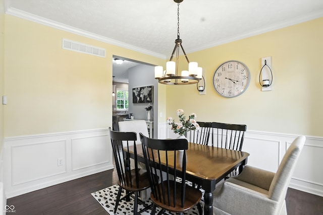 682 Shannon Ct, Noblesville, IN 46062 - dining space with a chandelier, dark wood-style floors, ornamental molding, a wainscoted wall, and a decorative wall