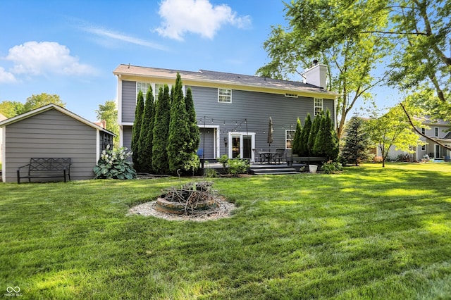 682 Shannon Ct, Noblesville, IN 46062 - back of property with a lawn, a fire pit, a chimney, and a deck