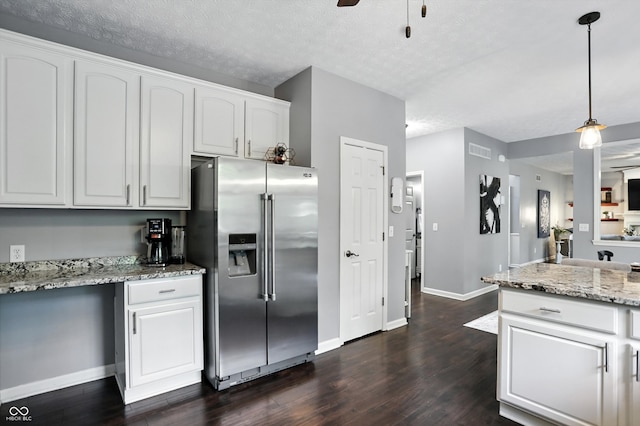 682 Shannon Ct, Noblesville, IN 46062 - kitchen featuring stainless steel fridge with ice dispenser, dark wood-type flooring, white cabinetry, light stone countertops, and decorative light fixtures