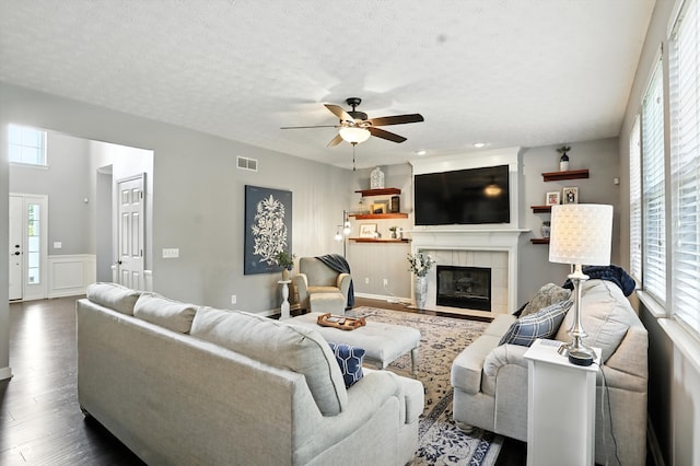 682 Shannon Ct, Noblesville, IN 46062 - living room featuring ceiling fan, dark wood finished floors, healthy amount of natural light, a fireplace, and a textured ceiling