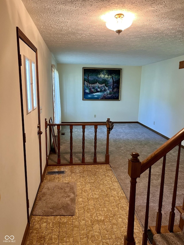 7057 Bluffwood Ct, Brownsburg, IN 46112 - corridor with carpet flooring, a textured ceiling, and stairway