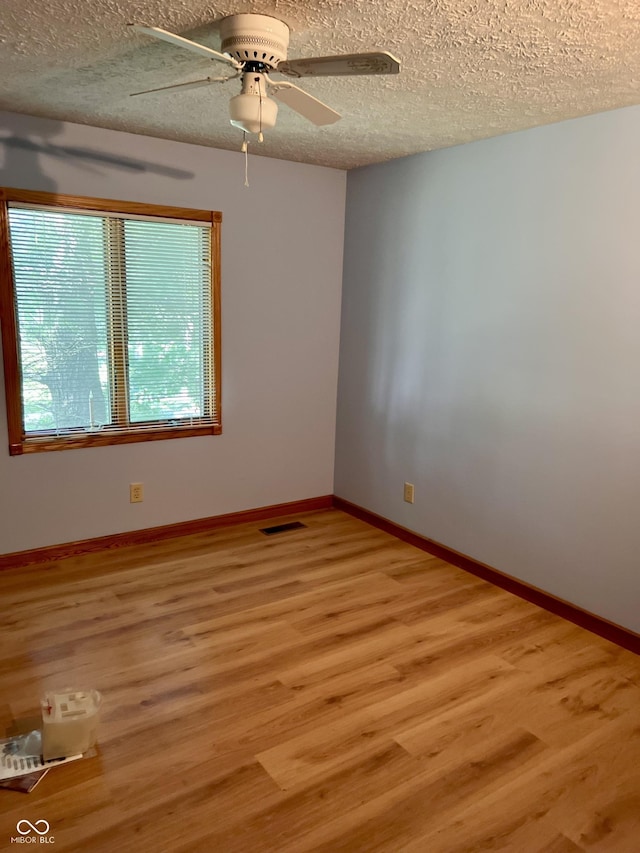 7057 Bluffwood Ct, Brownsburg, IN 46112 - empty room featuring light wood finished floors, ceiling fan, and a textured ceiling