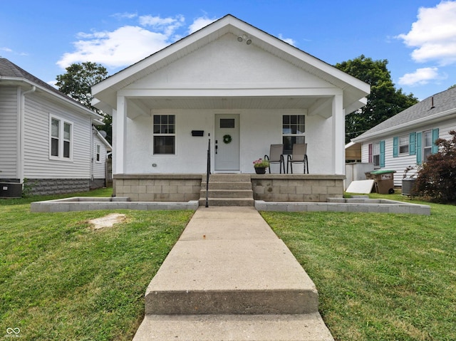 1830 Keller Ave, Columbus, IN 47201 - view of front of house featuring covered porch, a front yard, and stucco siding
