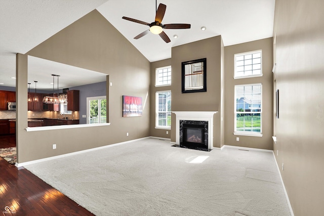 10267 Ranford Blvd, Fishers, IN 46040 - unfurnished living room featuring a towering ceiling, a ceiling fan, healthy amount of natural light, a high end fireplace, and recessed lighting