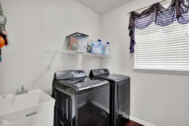 10267 Ranford Blvd, Fishers, IN 46040 - washroom with separate washer and dryer, dark wood-type flooring, and a textured ceiling