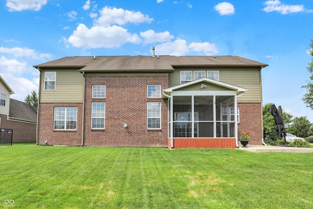 10267 Ranford Blvd, Fishers, IN 46040 - back of house featuring a sunroom, brick siding, and a lawn