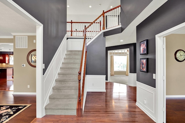 10267 Ranford Blvd, Fishers, IN 46040 - staircase featuring wood finished floors, wainscoting, and ornamental molding