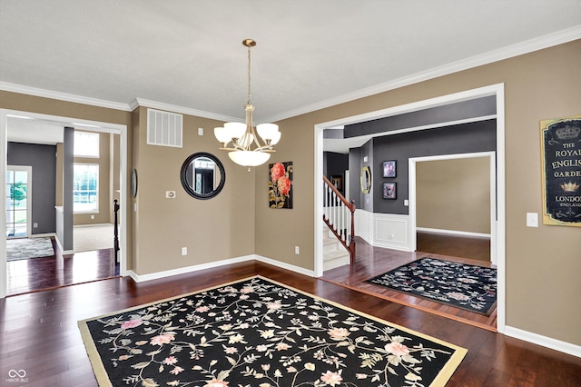 10267 Ranford Blvd, Fishers, IN 46040 - dining space featuring wood finished floors, a chandelier, ornamental molding, and stairway