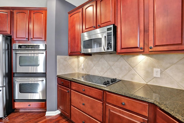 10267 Ranford Blvd, Fishers, IN 46040 - kitchen with black appliances, dark brown cabinets, dark wood-type flooring, dark stone counters, and tasteful backsplash