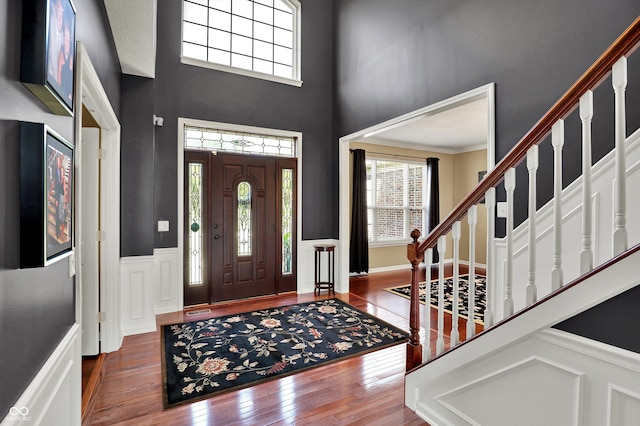 10267 Ranford Blvd, Fishers, IN 46040 - entryway featuring plenty of natural light, hardwood / wood-style floors, stairway, a decorative wall, and a wainscoted wall