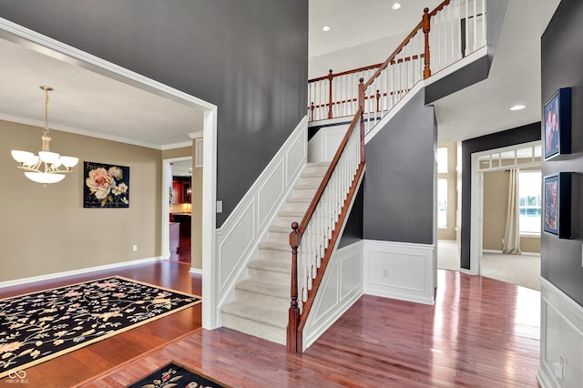 10267 Ranford Blvd, Fishers, IN 46040 - staircase featuring wood finished floors, a chandelier, crown molding, and recessed lighting