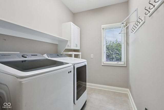 7927 Broadmead Way, Indianapolis, IN 46259 - washroom featuring washing machine and clothes dryer, cabinet space, and light tile patterned floors