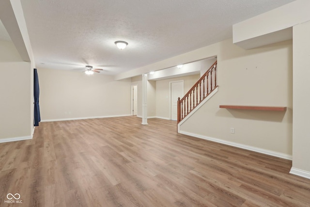 7927 Broadmead Way, Indianapolis, IN 46259 - unfurnished living room featuring light wood-type flooring, a textured ceiling, and stairs