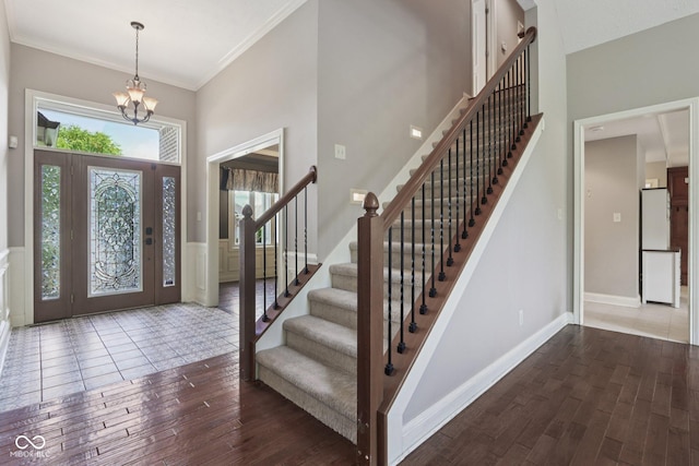 7927 Broadmead Way, Indianapolis, IN 46259 - foyer entrance with stairs, wood finished floors, a chandelier, and ornamental molding