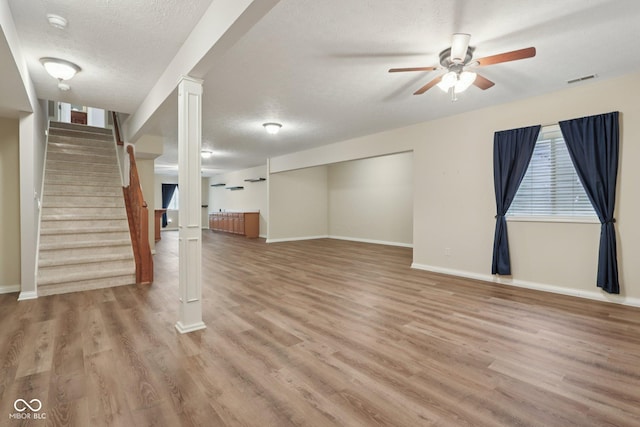 7927 Broadmead Way, Indianapolis, IN 46259 - unfurnished living room with ceiling fan, light wood-style floors, a textured ceiling, and stairs