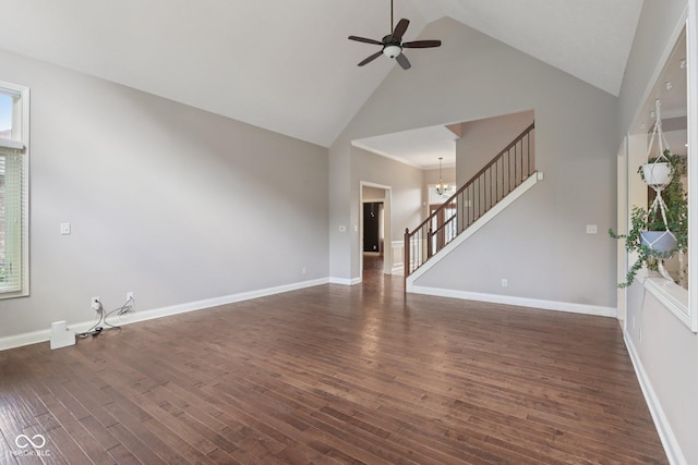 7927 Broadmead Way, Indianapolis, IN 46259 - unfurnished living room featuring stairway, high vaulted ceiling, ceiling fan, dark wood finished floors, and a chandelier