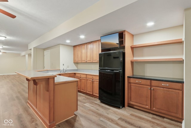 7927 Broadmead Way, Indianapolis, IN 46259 - kitchen featuring freestanding refrigerator, a peninsula, light wood finished floors, a ceiling fan, and a kitchen breakfast bar