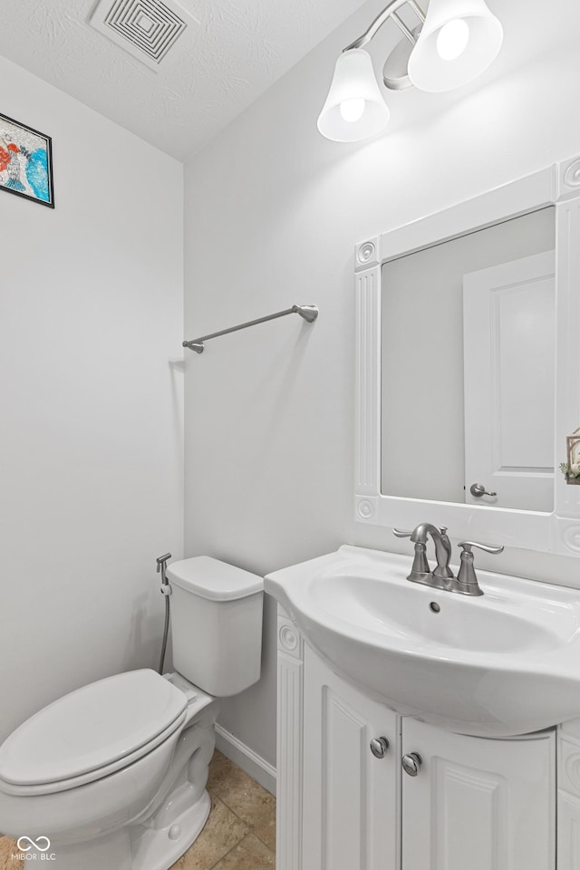 2833 Holiday Way, Greenwood, IN 46143 - half bathroom with vanity, a textured ceiling, and tile patterned flooring