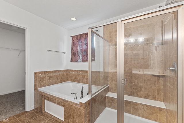 2833 Holiday Way, Greenwood, IN 46143 - bathroom featuring a bath, a stall shower, tile patterned floors, and a walk in closet