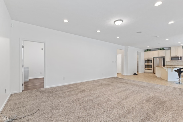 2833 Holiday Way, Greenwood, IN 46143 - unfurnished living room with light colored carpet and recessed lighting