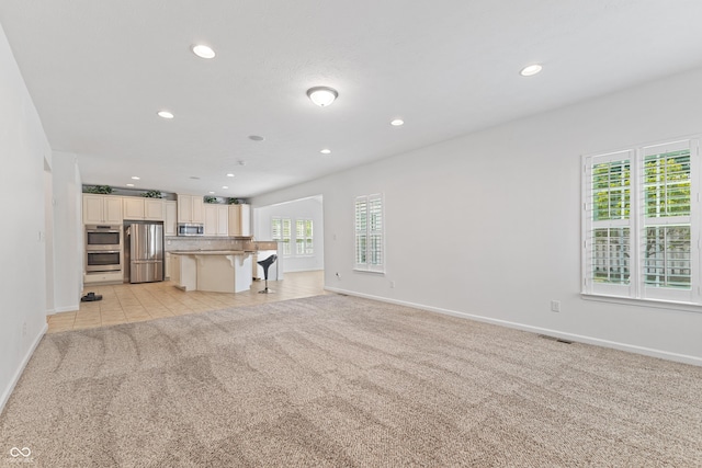 2833 Holiday Way, Greenwood, IN 46143 - unfurnished living room with light carpet, recessed lighting, and plenty of natural light