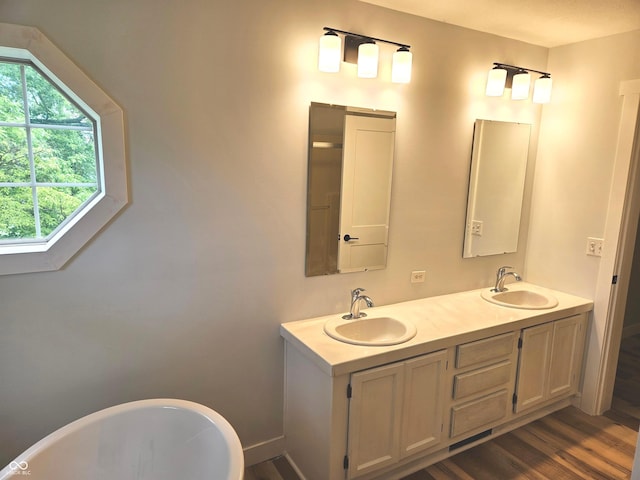 7422 S 575 W, Morgantown, IN 46160 - bathroom featuring a freestanding tub, double vanity, and wood finished floors