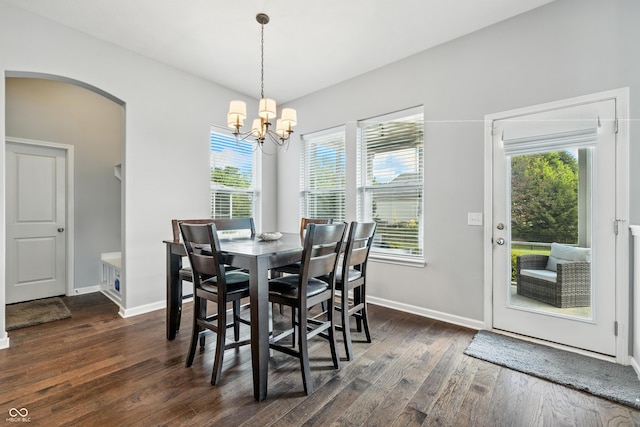 5875 Stroup Dr, Noblesville, IN 46062 - dining area with arched walkways, dark wood-style floors, a chandelier, and plenty of natural light