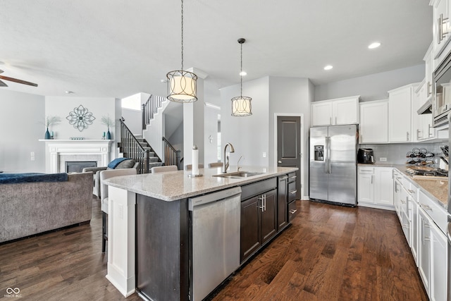 5875 Stroup Dr, Noblesville, IN 46062 - kitchen with stainless steel appliances, open floor plan, an island with sink, recessed lighting, and dark wood-style flooring