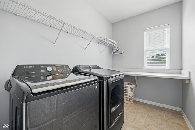 5875 Stroup Dr, Noblesville, IN 46062 - washroom featuring washing machine and clothes dryer and light tile patterned floors