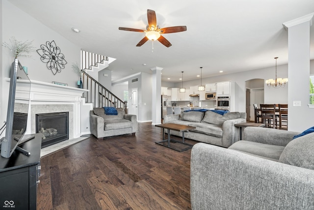 5875 Stroup Dr, Noblesville, IN 46062 - living area featuring dark wood-type flooring, a premium fireplace, ceiling fan, recessed lighting, and stairs