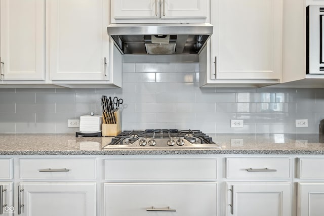 5875 Stroup Dr, Noblesville, IN 46062 - kitchen with exhaust hood, stainless steel gas stovetop, white cabinets, and tasteful backsplash
