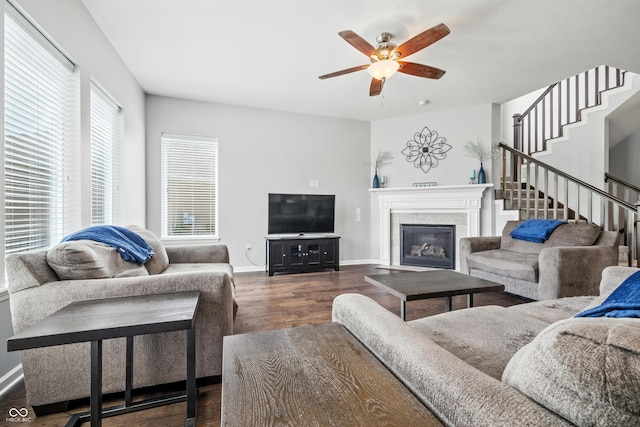 5875 Stroup Dr, Noblesville, IN 46062 - living room featuring dark wood-type flooring, a ceiling fan, stairway, and a tile fireplace