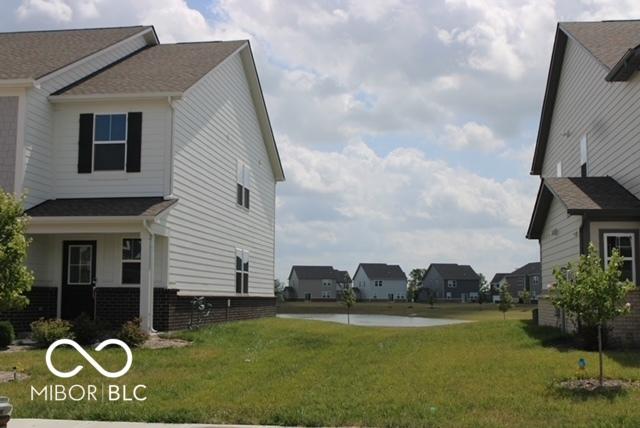 1573 Torrey Ln, Greenwood, IN 46143 - view of side of home with a lawn and a residential view