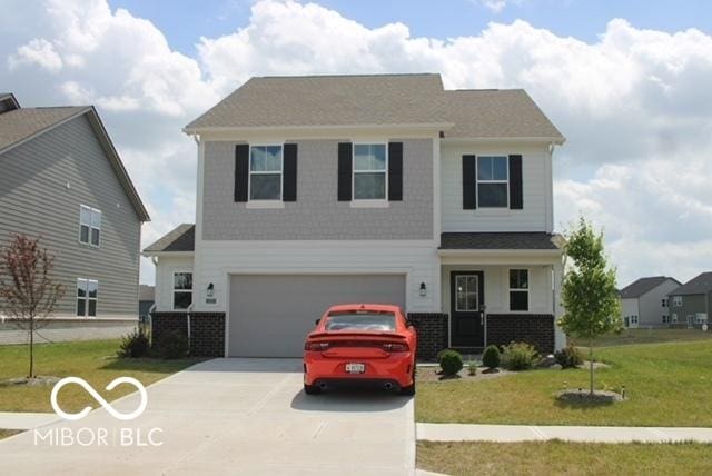 1573 Torrey Ln, Greenwood, IN 46143 - craftsman-style house featuring driveway, a front yard, an attached garage, and brick siding