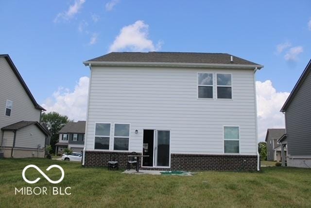 1573 Torrey Ln, Greenwood, IN 46143 - rear view of property with brick siding and a yard