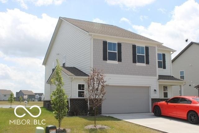 1573 Torrey Ln, Greenwood, IN 46143 - traditional home featuring concrete driveway, a front lawn, and a garage