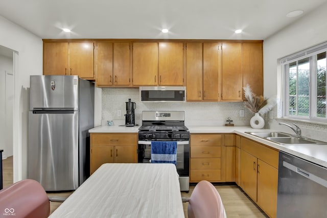 2149 Westline Dr, Columbus, IN 47203 - kitchen with appliances with stainless steel finishes, light countertops, decorative backsplash, recessed lighting, and light wood-type flooring