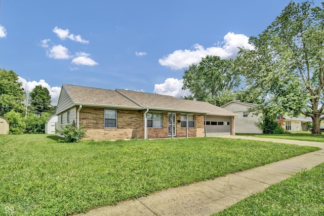 2149 Westline Dr, Columbus, IN 47203 - ranch-style house featuring brick siding, a garage, concrete driveway, a front yard, and roof with shingles