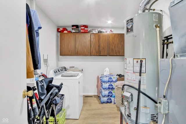 2149 Westline Dr, Columbus, IN 47203 - laundry area featuring water heater, washer and clothes dryer, light wood-style floors, cabinet space, and heating unit