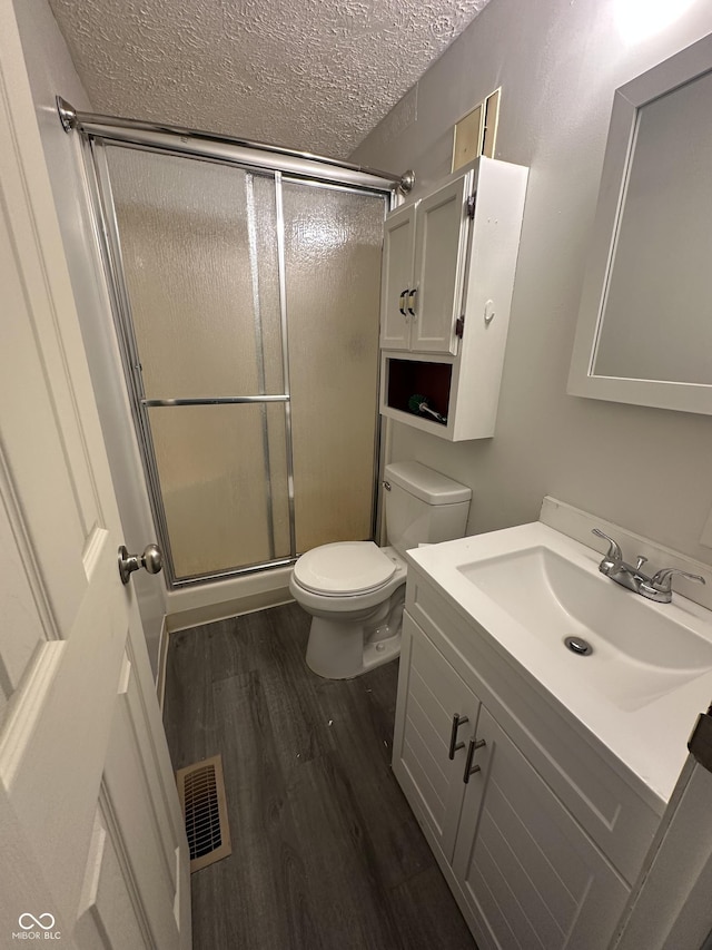 3708 Pleasant Creek Dr, Indianapolis, IN 46227 - bathroom with a textured ceiling, vanity, a stall shower, and wood finished floors