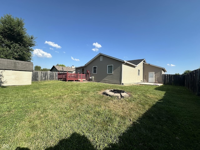 3708 Pleasant Creek Dr, Indianapolis, IN 46227 - back of house featuring a fenced backyard, a fire pit, a wooden deck, and a shed