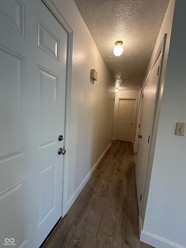 3708 Pleasant Creek Dr, Indianapolis, IN 46227 - hallway with a textured ceiling and dark wood-style floors