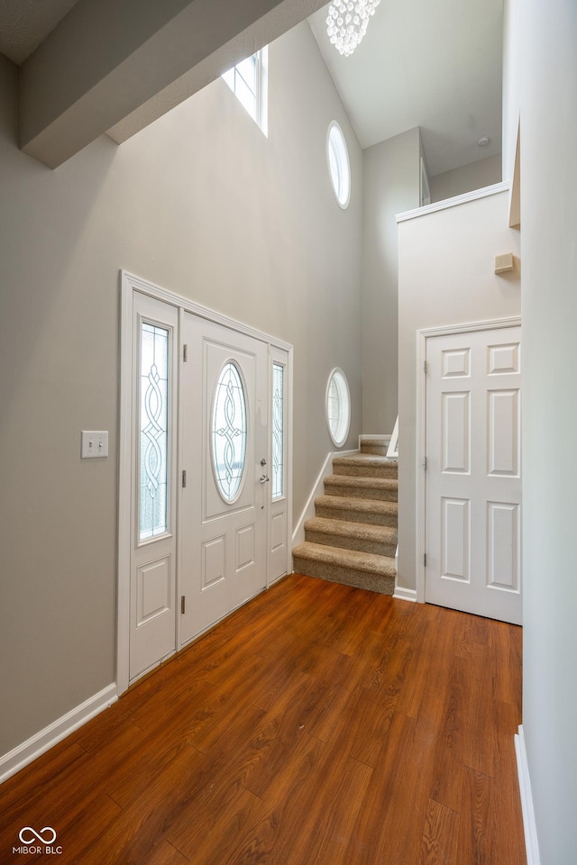 268 Larimar Dr, Whiteland, IN 46184 - foyer entrance featuring high vaulted ceiling, stairs, and wood finished floors