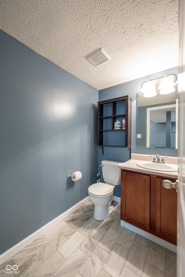 268 Larimar Dr, Whiteland, IN 46184 - bathroom featuring marble finish flooring, vanity, and a textured ceiling