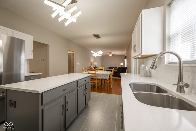 268 Larimar Dr, Whiteland, IN 46184 - kitchen featuring gray cabinets, light countertops, white cabinets, freestanding refrigerator, and a kitchen island
